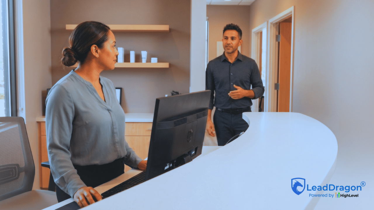 Two med spa administrative employees confer at a reception counter beside the consultation hallway.
