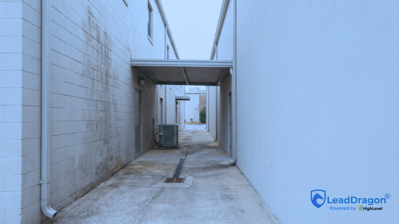 Commercial building exterior with varied surfaces, limited access, and utility obstacles that may require an onsite pressure washing review.